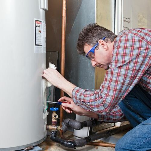 A Plumber Checks a Water Heater