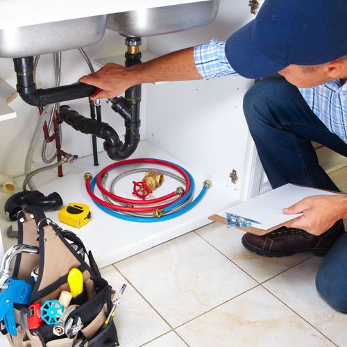 A Plumber Inspects Pipes.